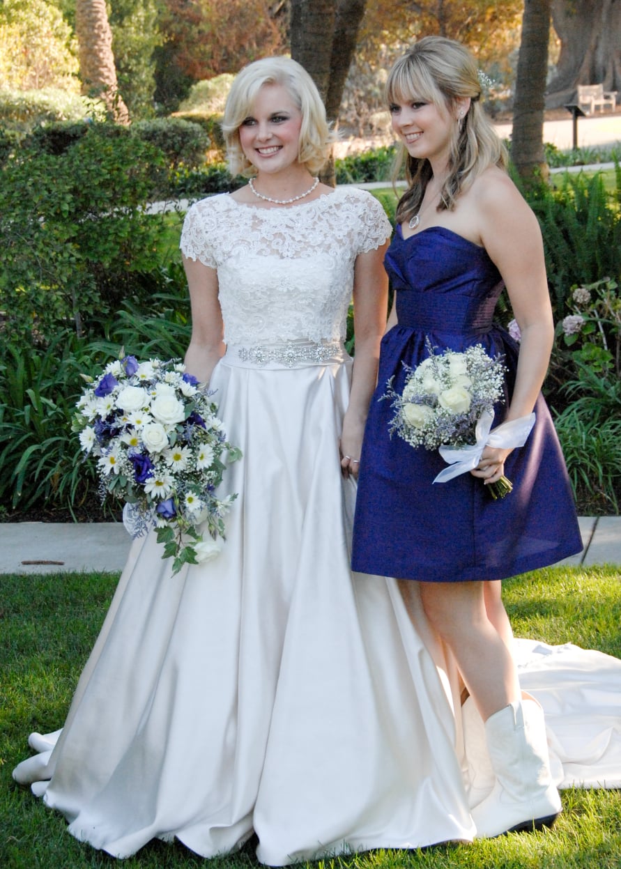 Bride with maid of honor holding bouquets before wedding