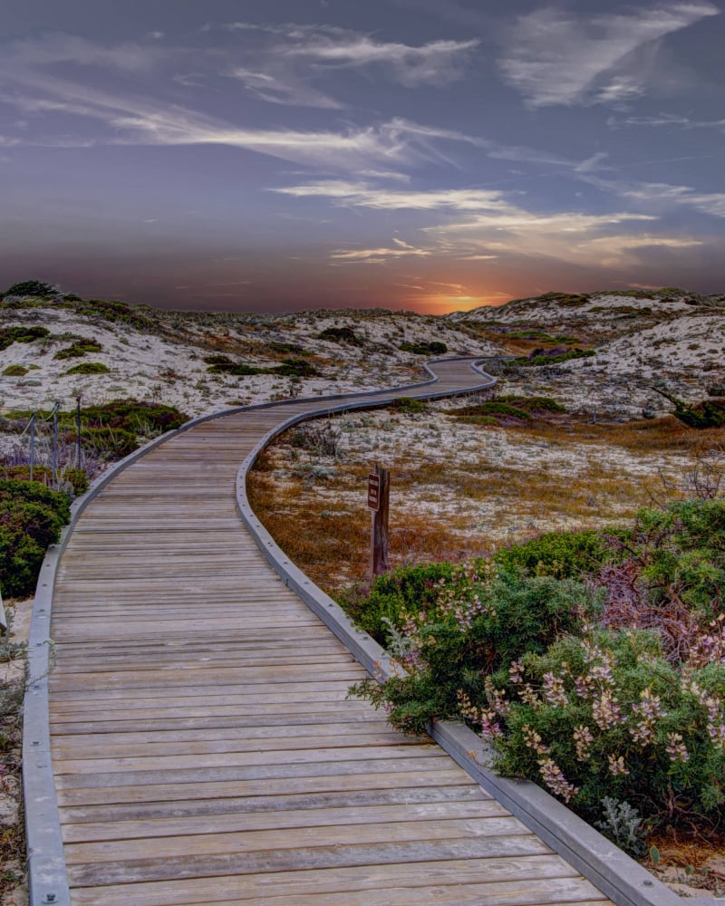 Board walk on beach under the sunset